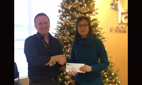 Pictured here with Union Rep David, Sophie's mom Jing Zhou accepts her daughter's scholarship winnings