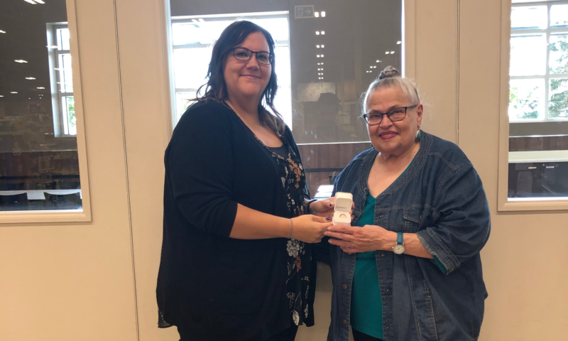 Kay Gusso (R) is presented with retirement ring by Union Rep Char