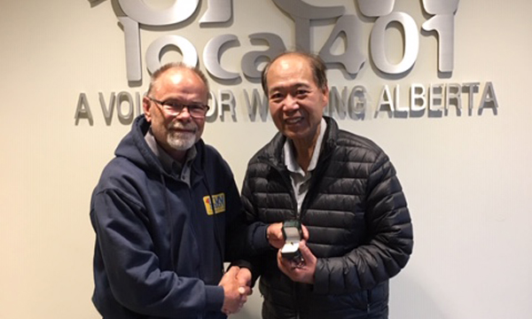 Ken (pictured on right) receives his retirement ring from his union rep John