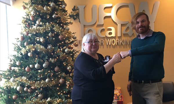 Marian Ehry is pictured here being presented with her UFCW 401 retirement ring by her union rep Jeff