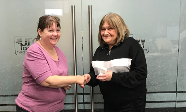Georgina (right) picks up her 401 retirement ring from her Union Rep and former Safeway co-worker Cheryl