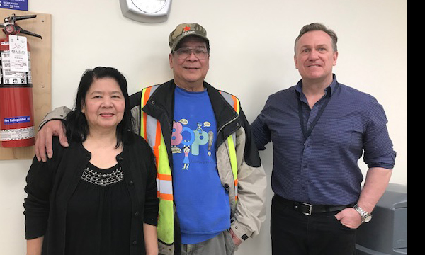Rolando (centre), accompanied by his wife, receives his retirement ring from his Union Rep David