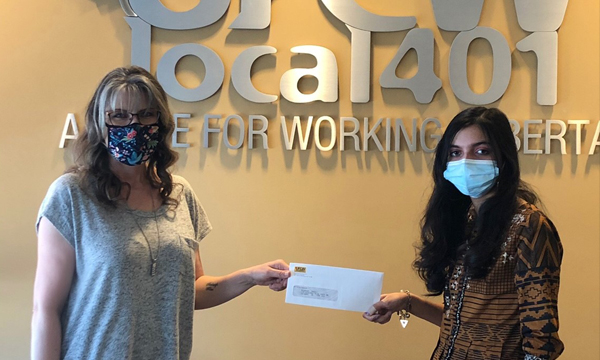 Areej receives her cheque from UFCW 401 admin Tammy