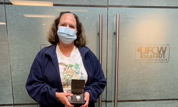 Long time activist and member Mary receives her retirement watch