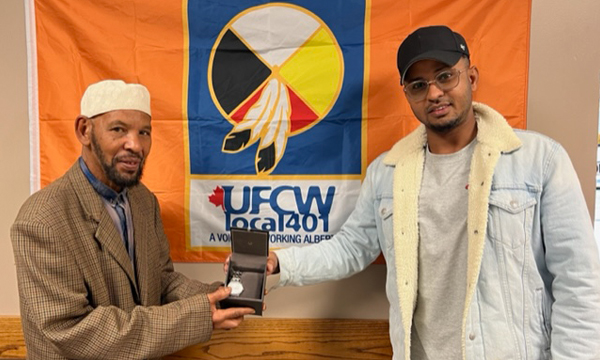 Adem (L) is pictured here receiving his retirement gift from steward Abdalateef