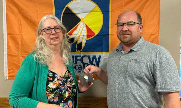 Cynthia receives her retirement gift from relief rep Geoff