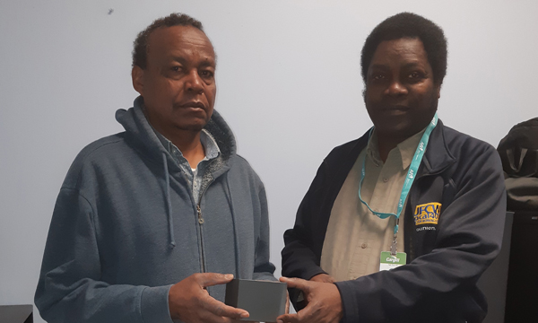 Ahmed recieves his retirement watch from Walking Steward Joseph