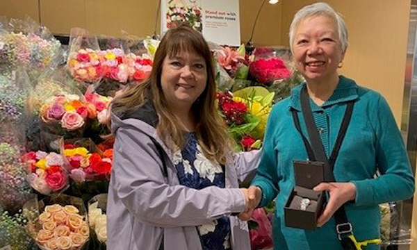 Mary (R) gets a visit from her union rep Cheryl who presents her with her retirement gift