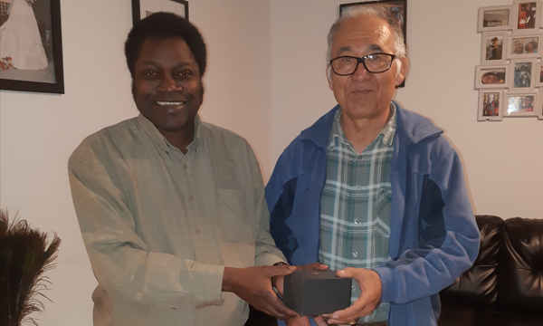 Shamsodin receives his retirement gift from Walking Steward Joseph
