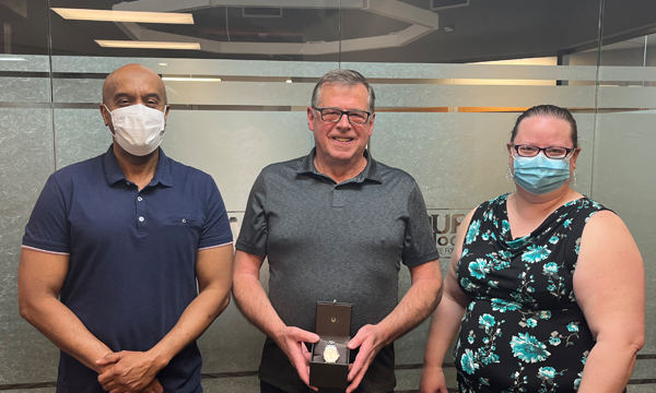 Dave receives his retirement gift from Union Rep Abdi and Walking Steward Nicole