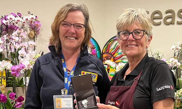 Lori is presented with her retirement watch from Walking Steward Margaret