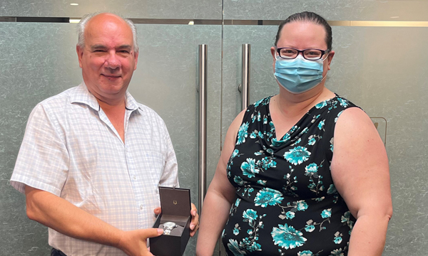 Gerald receives his retirement gift from Safeway Walking Steward Nicole