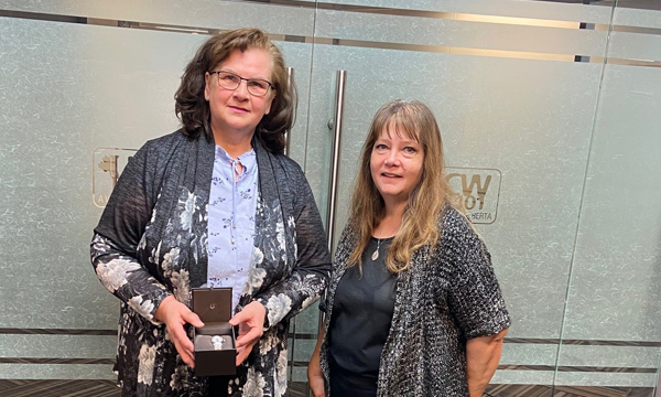 Nadine drops by the union office to collect her retirement watch from her union rep Cheryl