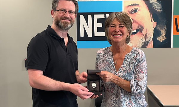 Brenda pops by the union office to pick up her retirement watch from her Union Rep Aaron