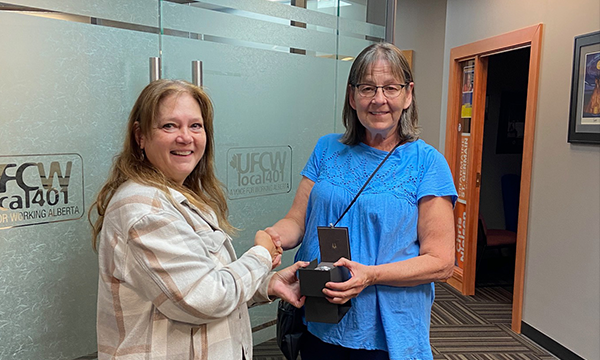 Wendy stops by the union office to pick up her retirement watch from her Union Rep Cheryl